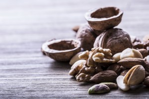 Almonds, walnuts and hazelnuts on wooden table